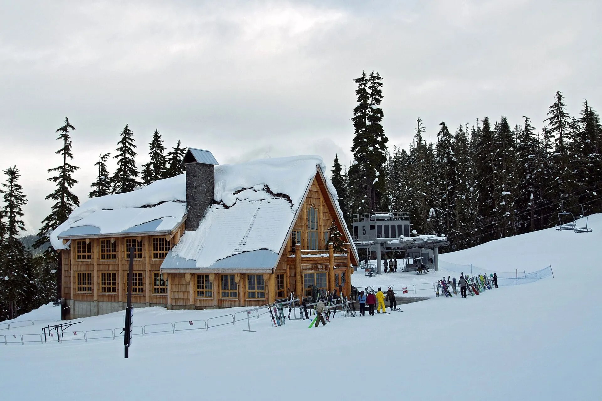 Deep snow loading the roof of a timber day lodge beside the Chair 5 terminal at Mt. Baker Ski Area